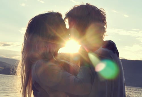 couple kissing on morning sunshine